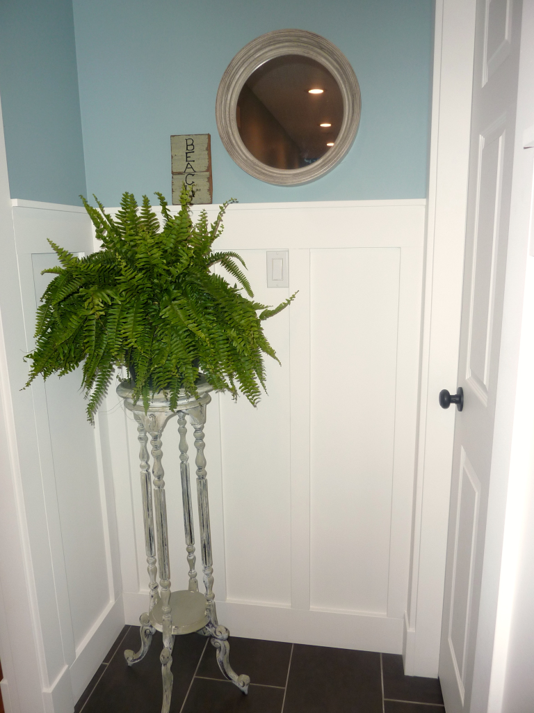 plant stand and mirror end of hallway at thehappyhousie