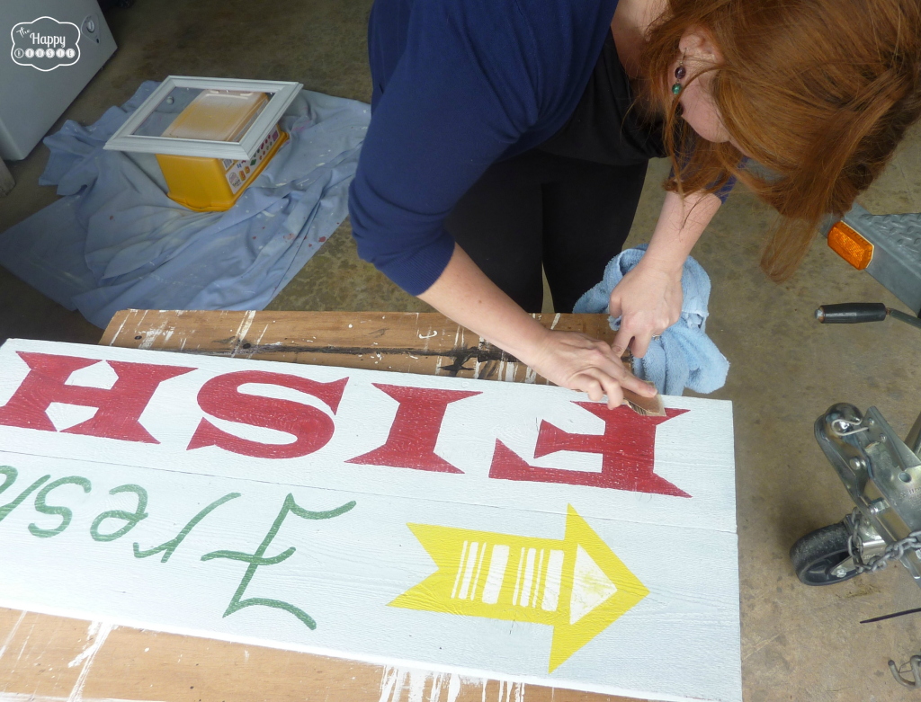 PUtting the finishing touches onto the sign.