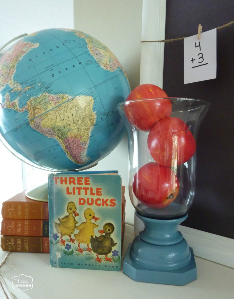back to school mantel with vintage globe, vintage books, hurricane with apples, flash cards, chalkboard at thehappyhousie