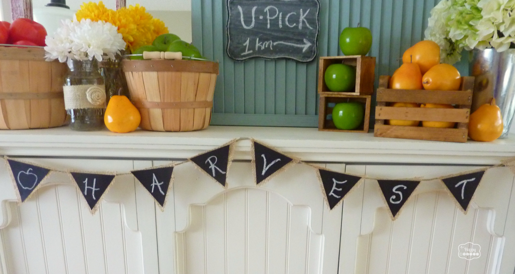early fall mantel with burlap and faux chalkboard bunting at thehappyhousie