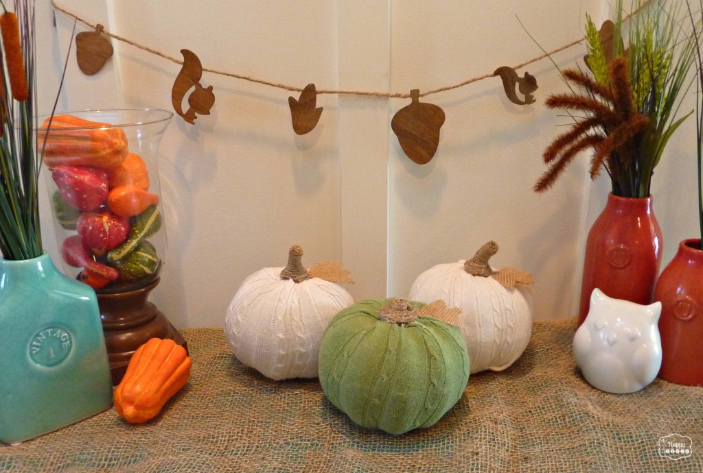 The DIY sweater pumpkins in a fall display.