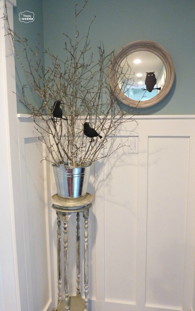 Halloween House Tour end of the hall plant stand with branches and crows at thehappyhousie