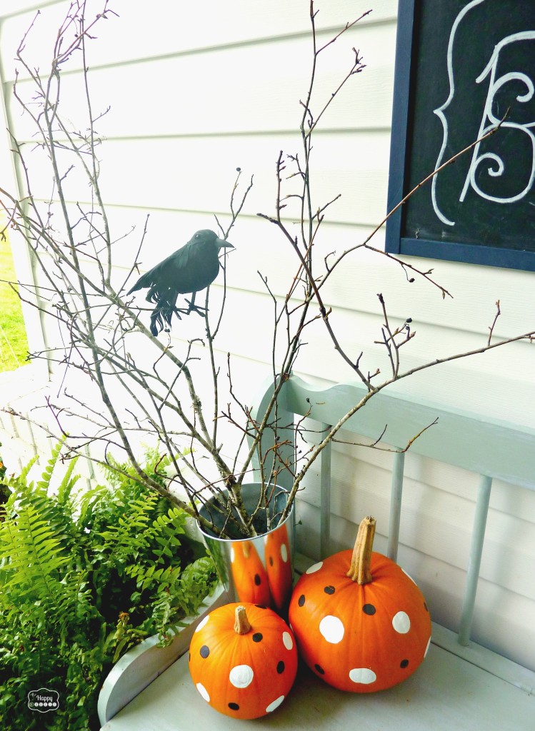 Halloween front porch with branches and crows and polka dot pumpkins