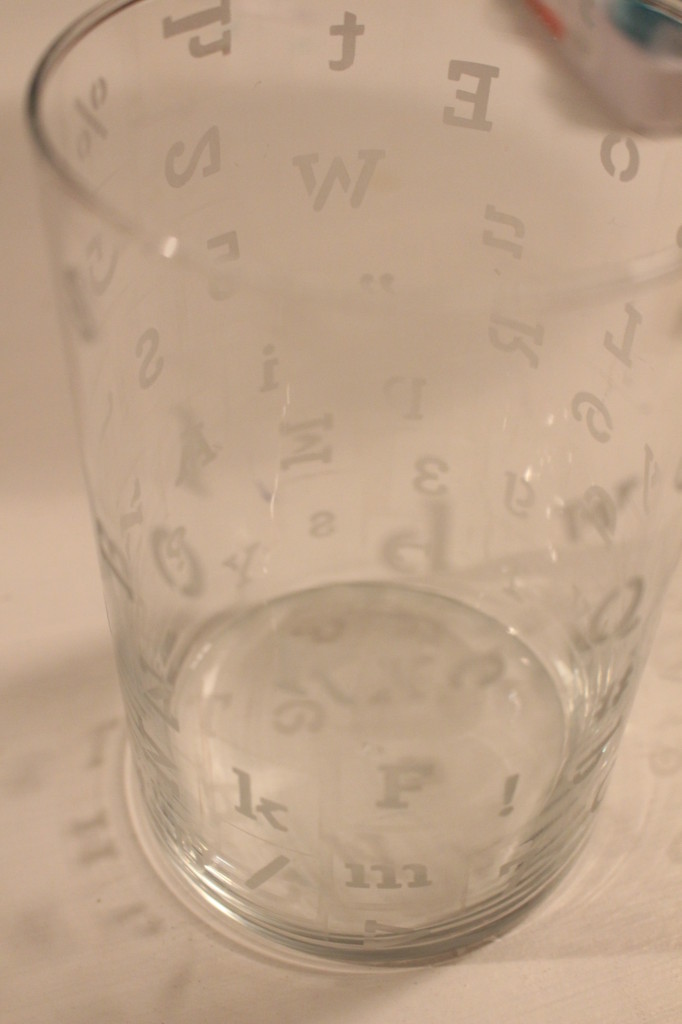 The etched letters and numbers on the glass.