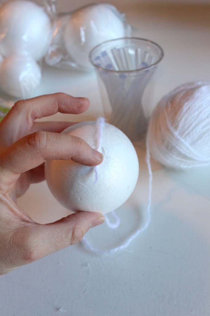 Wrapping the yarn around the styrofoam balls.