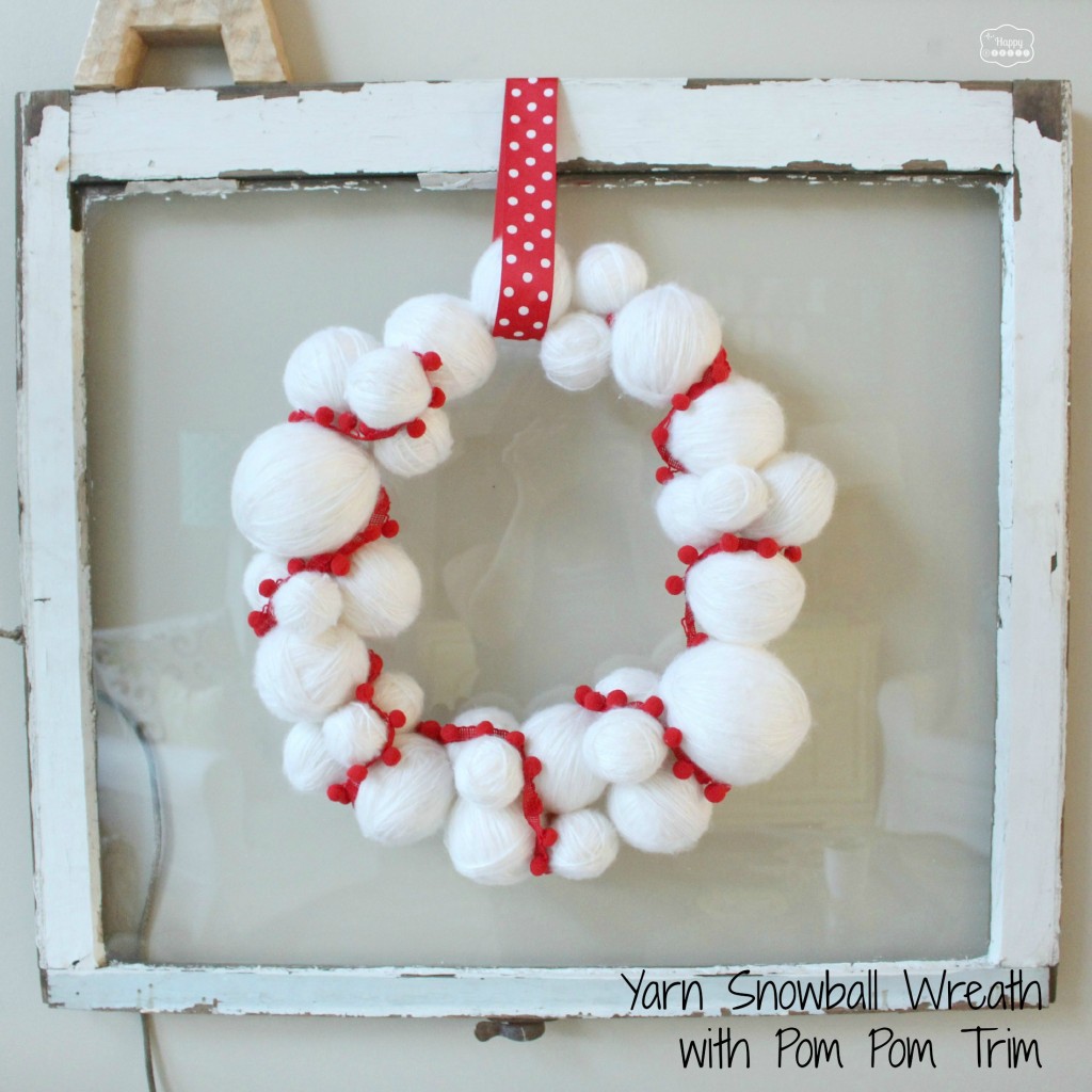 yarn snowball wreath with pom pom trim at thehappyhousie