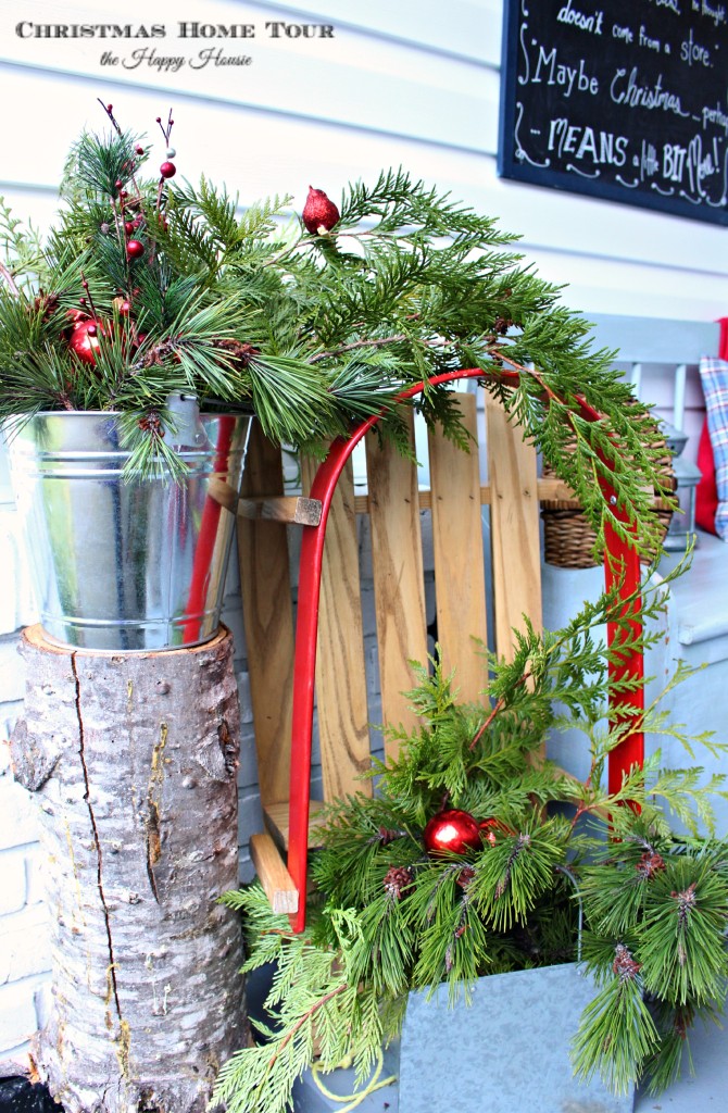 The Happy Housie Christmas Home Tour front porch sleigh and greenery