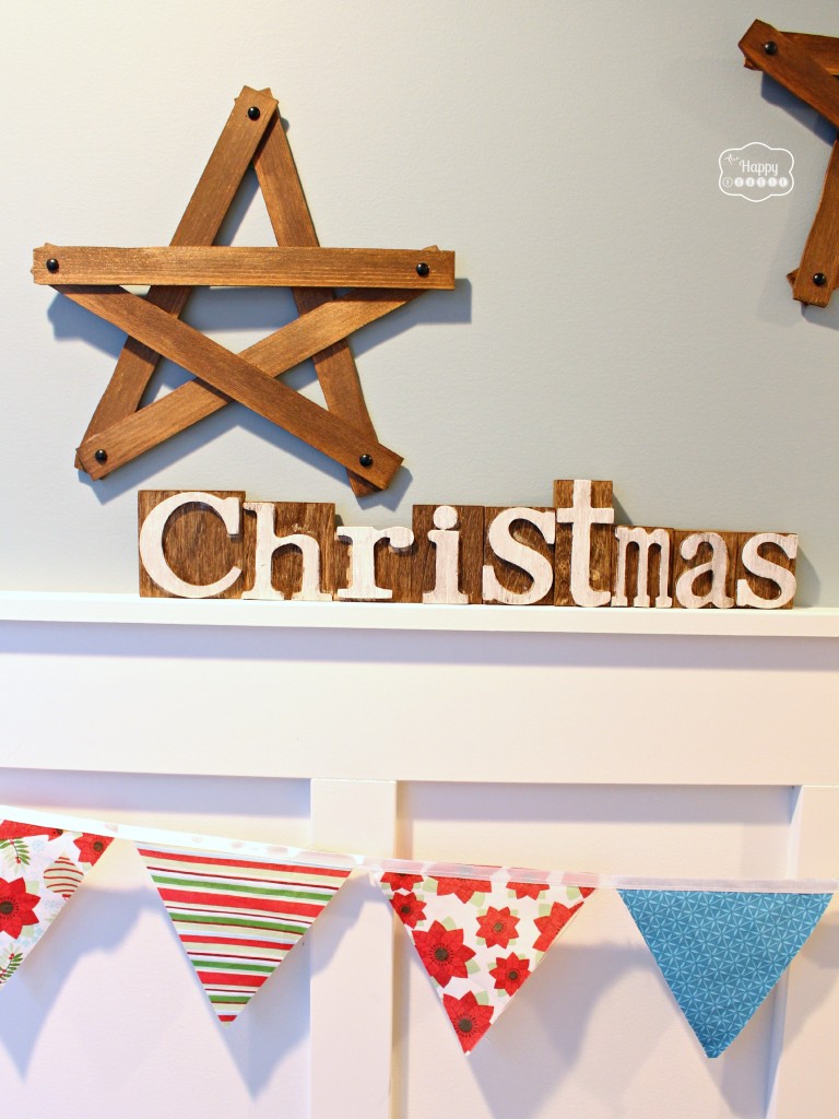 A Christmas sign is below the star on the wall.