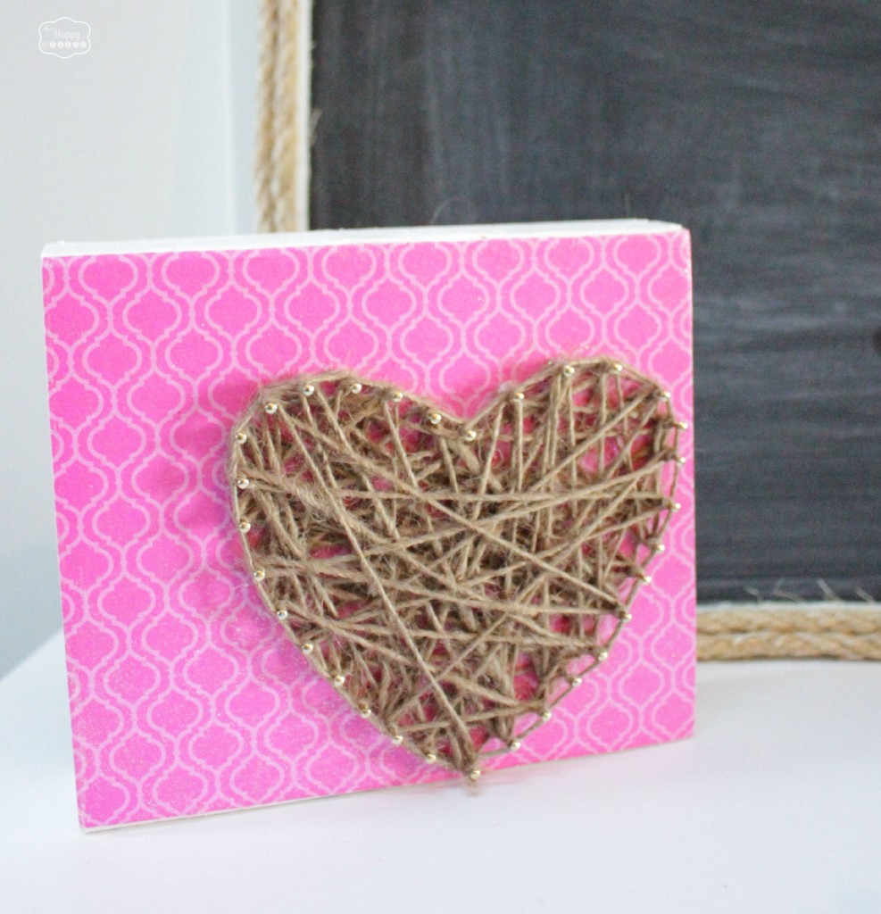 The heart on a pink background by a chalkboard.