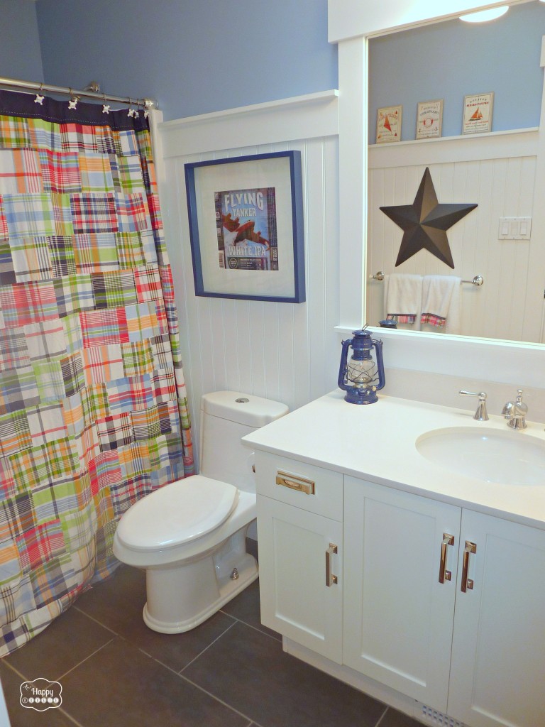 A multicoloured shower curtain, a large star on the wall and updated pulls on the cabinet.