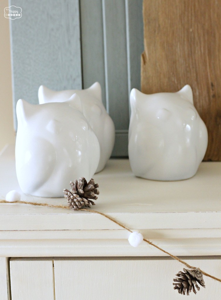 The Happy Housie January Blues Winter Mantel with white owls and pompom pinecone garland