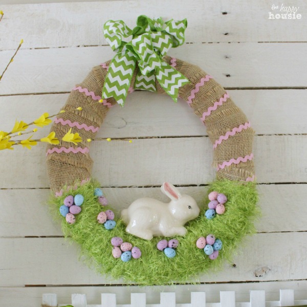 Pink, green, purple and yellow spring bunny wreath hanging up.