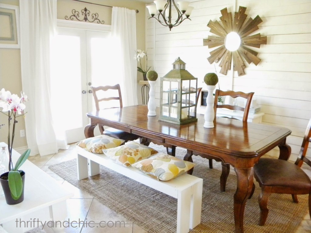 Thrifty and Chic Dining Room with a large sunburst mirror.