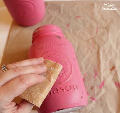 Pink and Gold Chalk Painted Mason Jars sanding to distress at The Happy Housie