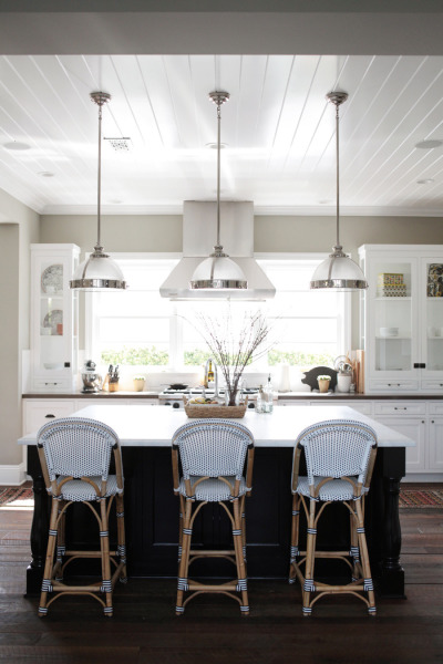 Steel and white lights are above the kitchen island.